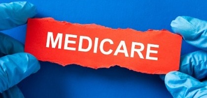 doctor-holds-a-red-paper-with-the-word-medicare-medical-inusrance-picture-id1324137081