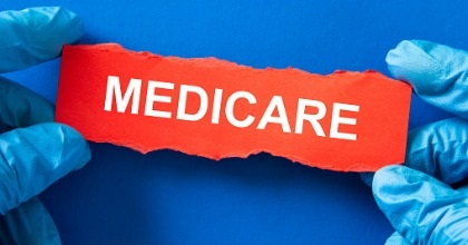 doctor-holds-a-red-paper-with-the-word-medicare-medical-inusrance-picture-id1324137081